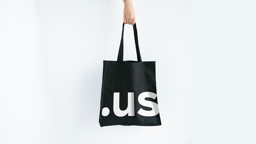 Hand holding black minimalistic design tote bag